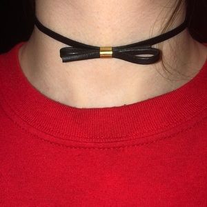 A black bow choker with gold detailing
